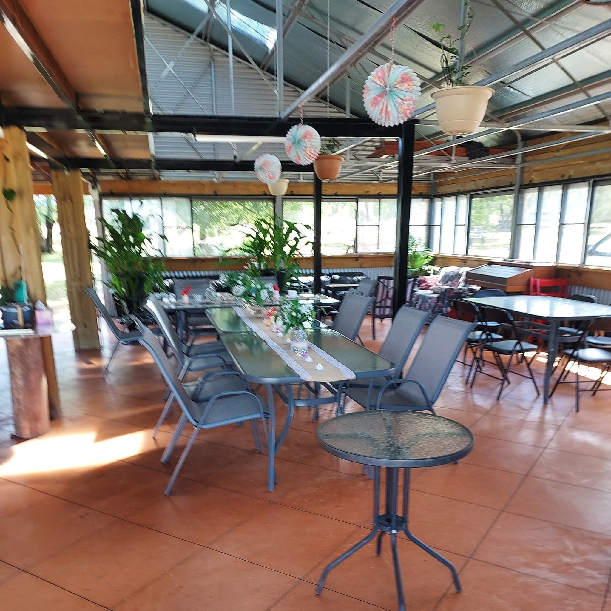 Indoor seating area at Evergrow Farm Hub Café with modern rustic décor and large tables for group bookings.