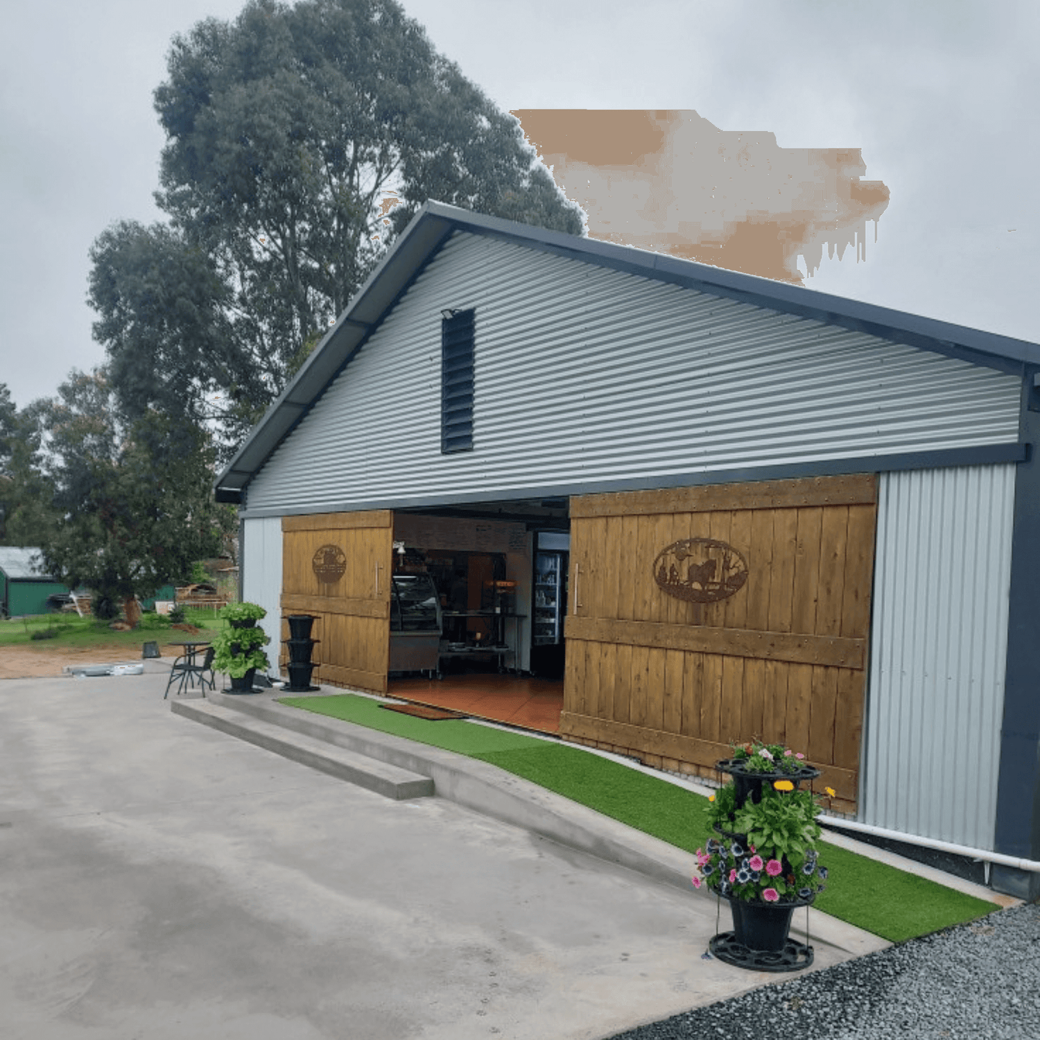 White farm building with wooden paneling