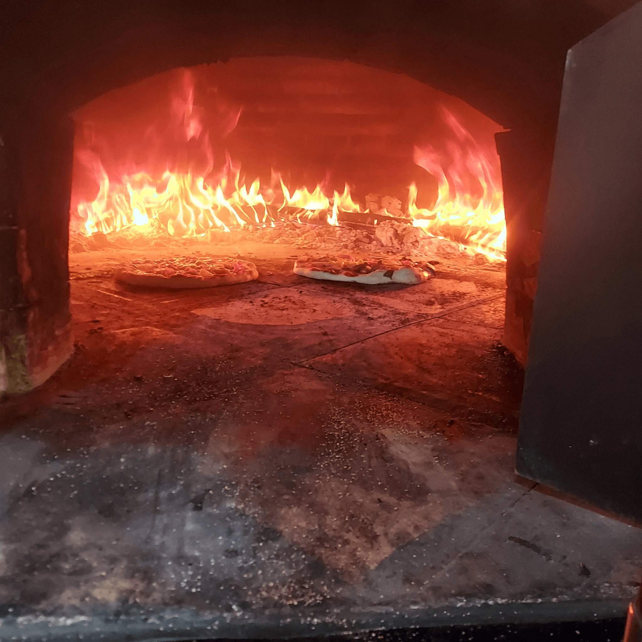 Woodfire pizza cooking at Evergrow Farm Hub Cafe