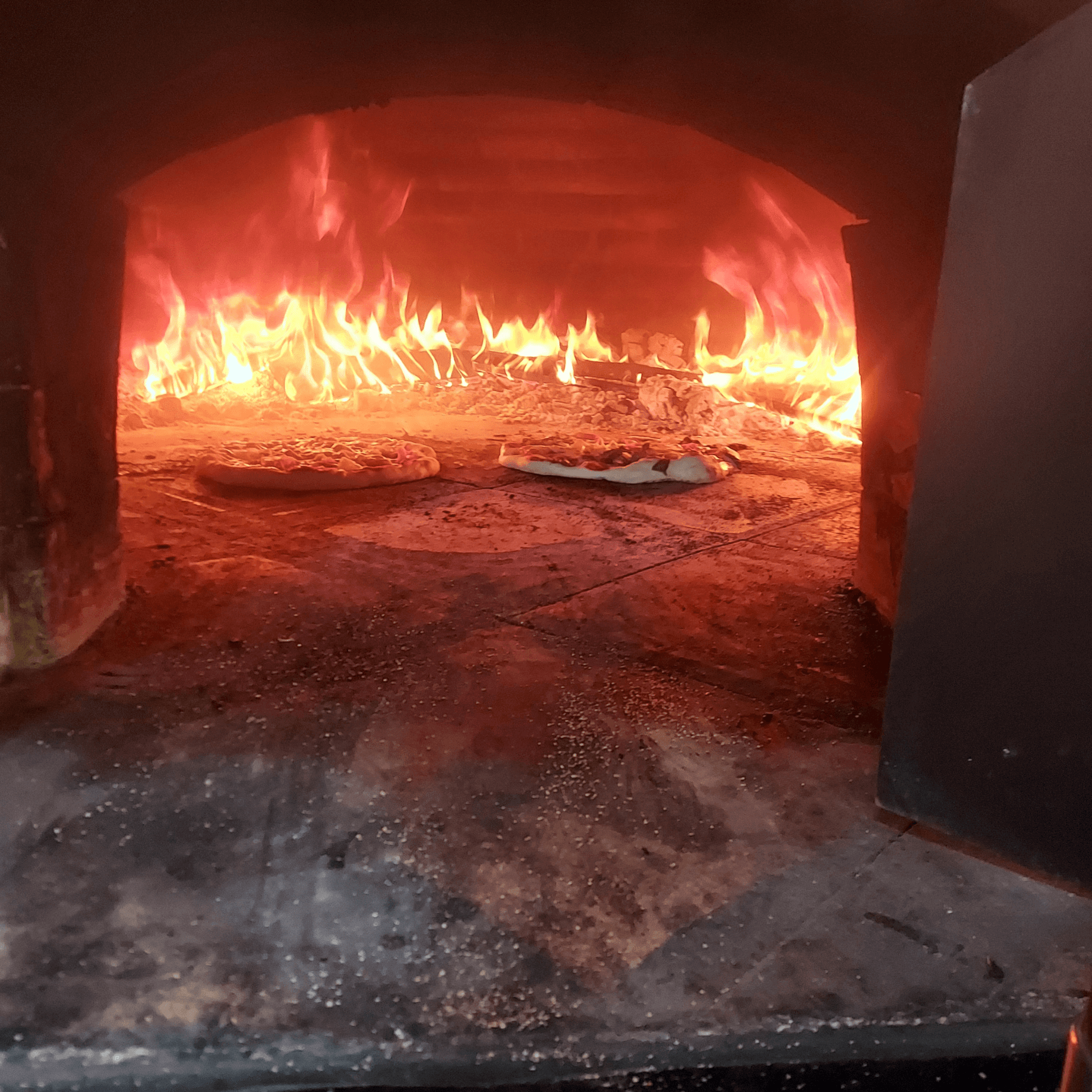 Woodfire pizza cooking at Evergrow Farm Hub Cafe