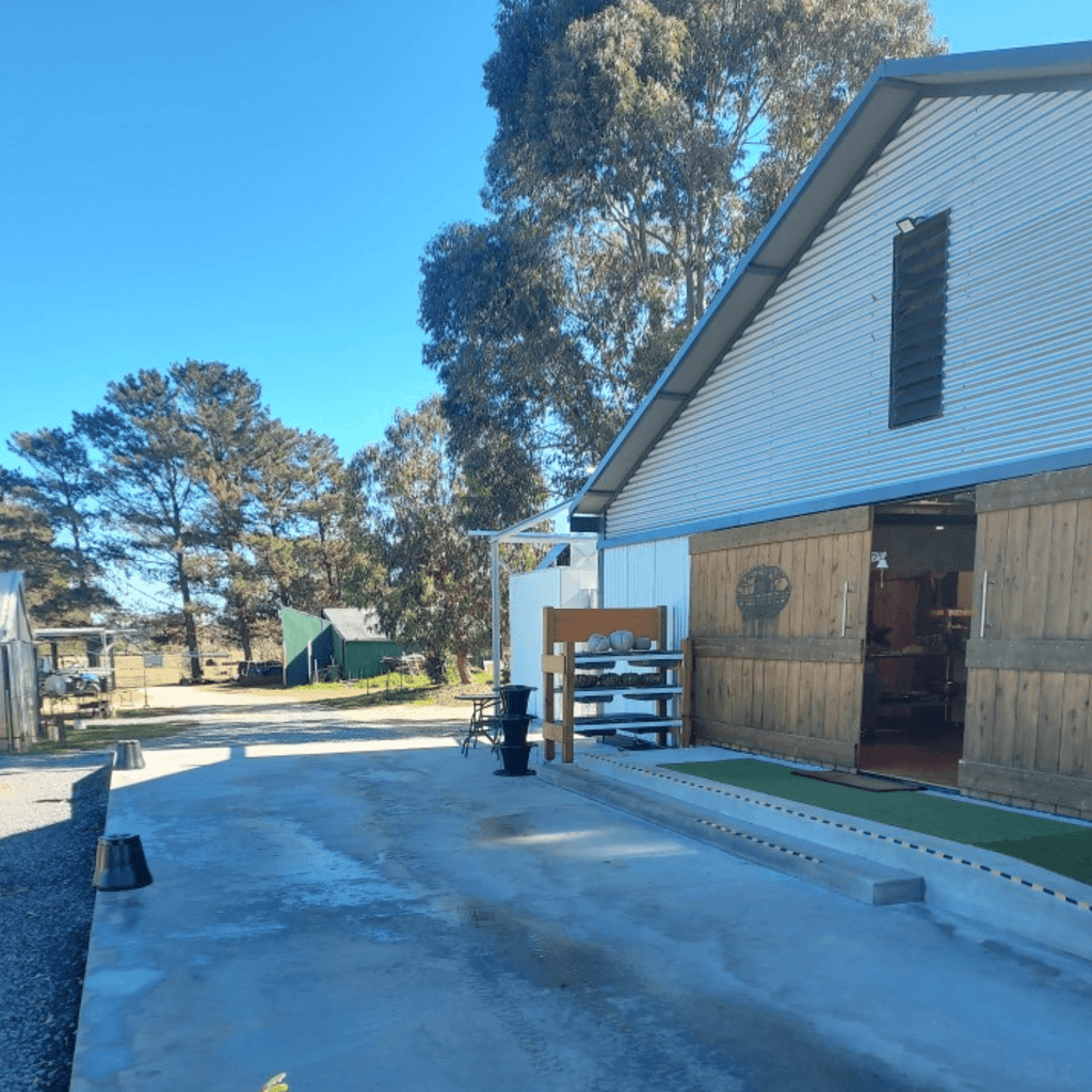 Outdoor view of Evergrow Farm venue hire space with rustic barn-style building in Inverell.