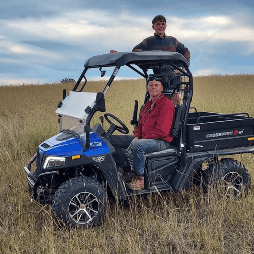School holiday activities family farm experience with kids enjoying a farm tour on an ATV in open paddock